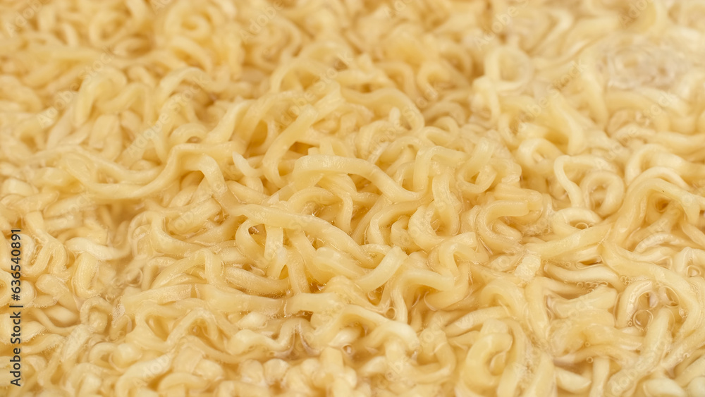 Fototapeta premium Noodles boiled in boiling hot water on pan