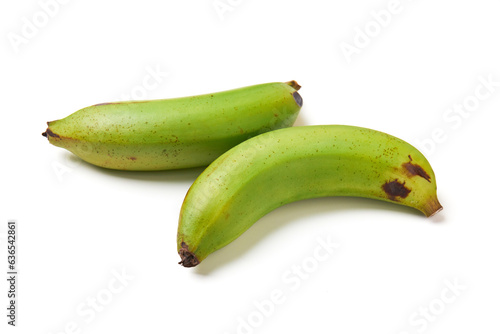 2 unripe bananas (green) isolated on white background, unripe bananas are versatile, high in fiber, help with weight loss, good source of vitamins, good for diabetics and treat acid reflux.