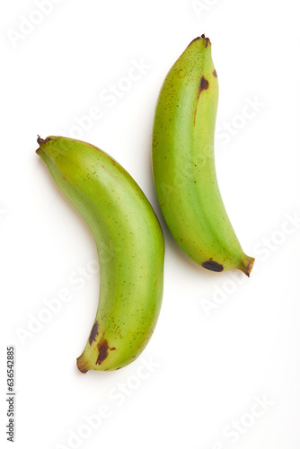 2 unripe bananas (green) isolated on white background, unripe bananas are versatile, high in fiber, help with weight loss, good source of vitamins, good for diabetics and treat acid reflux.