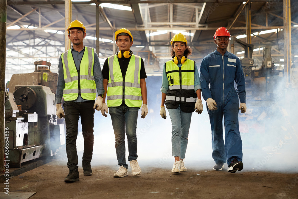 portrait group of engineers or workers walking and looking forward in the factory portrait group of engineers or workers walking and looking forward in the factory