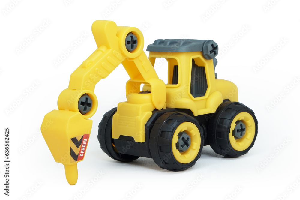 yellow plastic tractor drill toy isolated on white background. heavy construction vehicle.