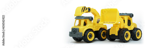 yellow plastic truck and bulldozer toy isolated on white background with copy space for text or banner © thebaikers