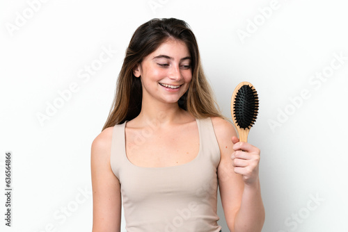Young woman with hair comb isolated on white background with happy expression