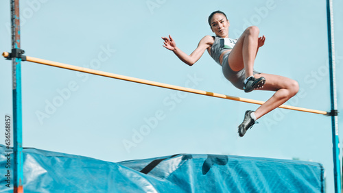 Fotografia High jump, woman and fitness with exercise, sport and athlete in a competition outdoor