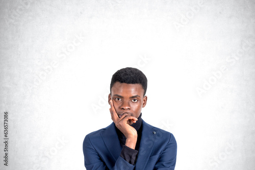 Young African American businessman thinking, portrait photo