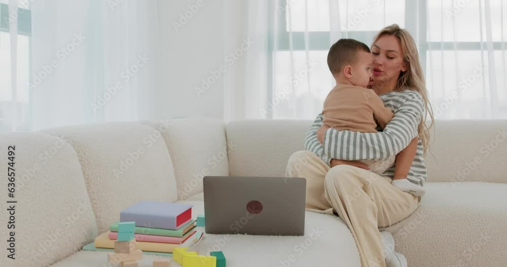 noblest of profession. young Caucasian family mother and child cuddle hug on sofa, Slow motion mommy turning on laptop and show cartoon to her cute kid, woman calm down her naughty son noblest of profession. young Caucasian family mother and child cuddle hug on sofa, Slow motion mommy turning on laptop and show cartoon to her cute kid, woman calm down her naughty son