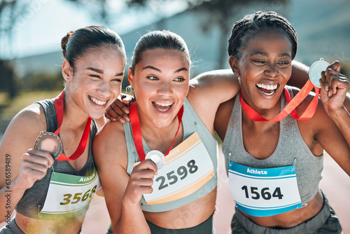 Fototapeta Naklejka Na Ścianę i Meble -  Happy women, award and celebration in olympic winning, running or competition together on stadium track. Group of athletic people smile in happiness, medal or victory in sports marathon or success