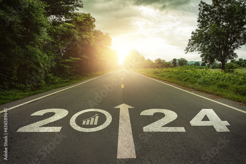 2024 Goal plan action, Business target and growth strategy. Business annual plan and development for achieving goals and success. 2024 written on the road in the middle of asphalt road with at sunset. photo