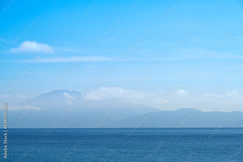 Mediterranean sea, blue sky and clouds with mountains in Africa