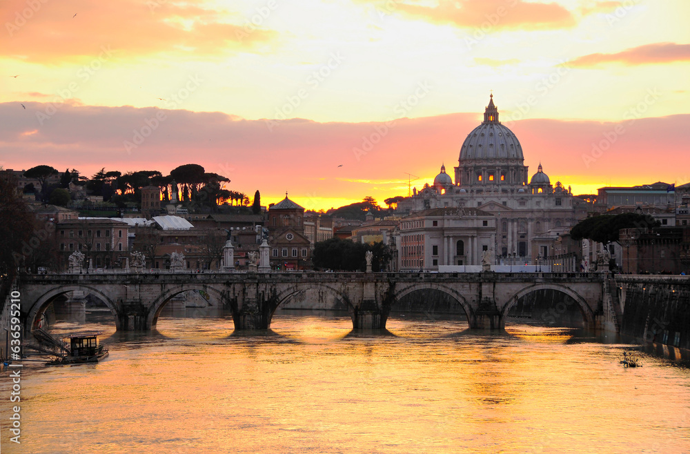 Sunset over St. Peters Basilica and Sant'Angelo bridge in Rome.