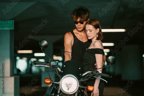fashionable couple motorcyclist and woman near the motorcycle. Motorcycle love. © velimir