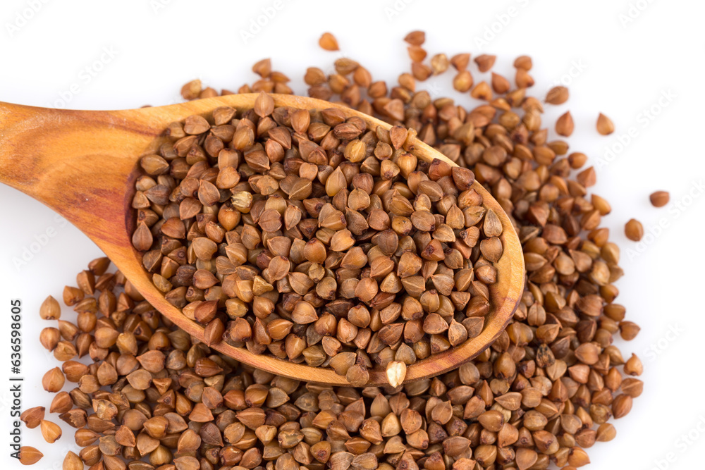 Fototapeta premium Uncooked buckwheat on wooden spoon