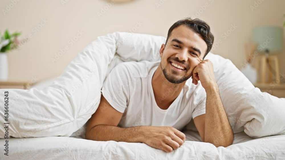 Young hispanic man smiling confident lying on bed at bedroom Young hispanic man smiling confident lying on bed at bedroom