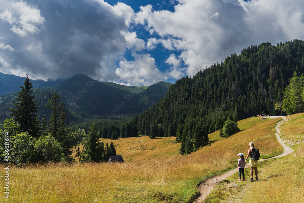 Beautiful mountain landscape.  Mother and daughter walk in the mountains in the Tatras in summer.