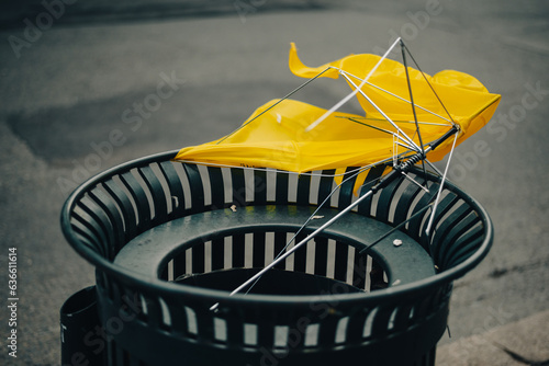Broken umbrella in the trash can