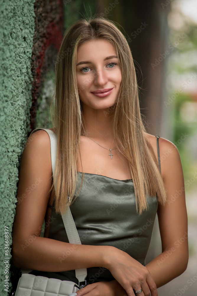 Portrait of a beautiful fair-haired girl near the wall of the house. Portrait of a beautiful fair-haired girl near the wall of the house.