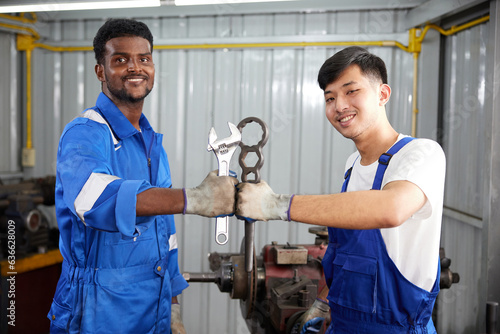 workers or technicians holding wrench and fist bump pose in the factory © offsuperphoto