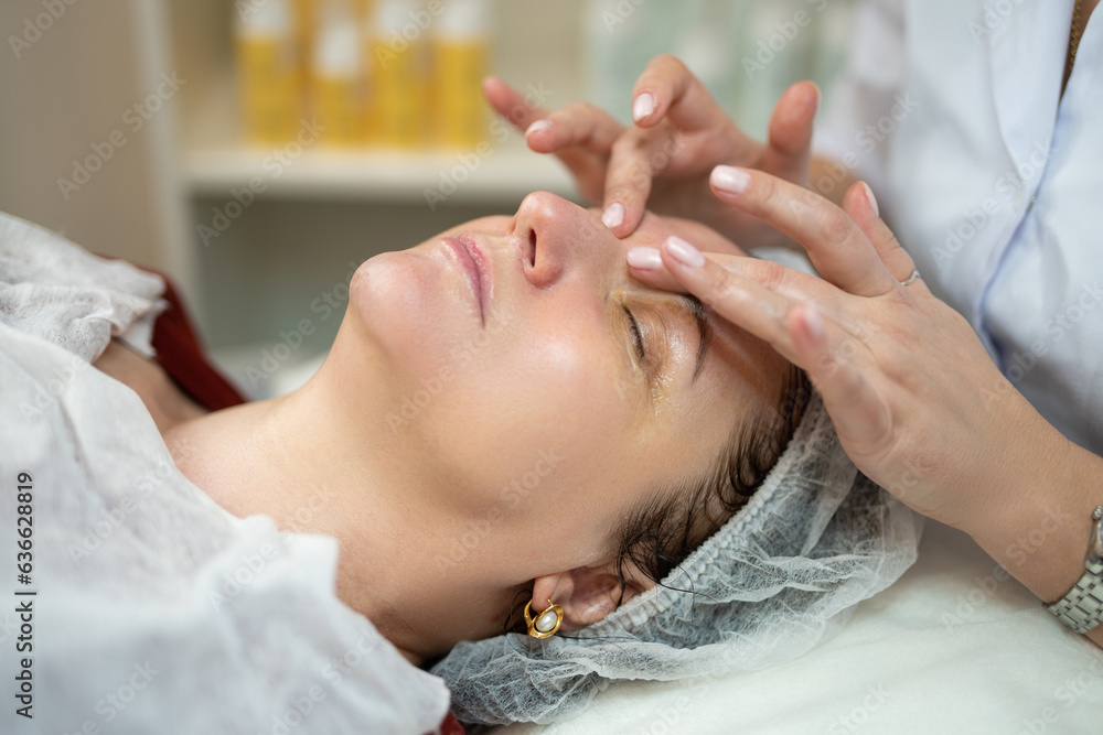 close-up of a girl's face at a cosmetologist during treatment procedures close-up of a girl's face at a cosmetologist during treatment procedures