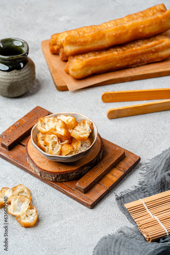 Youtiao or Yu Char Kway is a long golden-brown deep-fried strip of wheat flour dough of Chinese origin photo