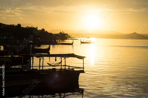Talisay, Batangas, Philippines - December 25, 2015: Tourist Boat anchored at Lakeshore seen during sunrise that cater to interisland tourist travelers. Silhouettes
