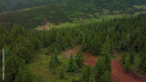 Wallpaper Mural Aerial Descending Forward Over Car On Dirt Road Amidst Green Trees In Forest - Colorado Springs, Colorado Torontodigital.ca