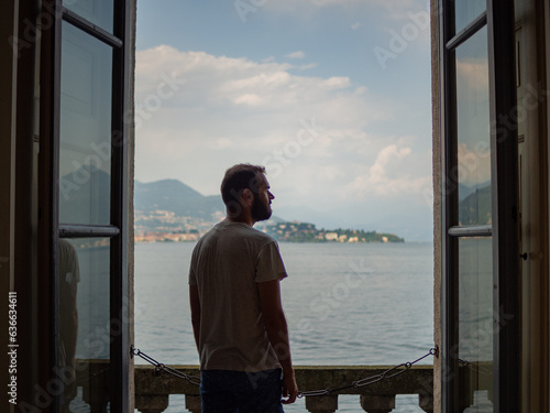Young man enjoying beautiful views of a palace in Stresa Italy in the Isola Bella island. © MalaikaCasal