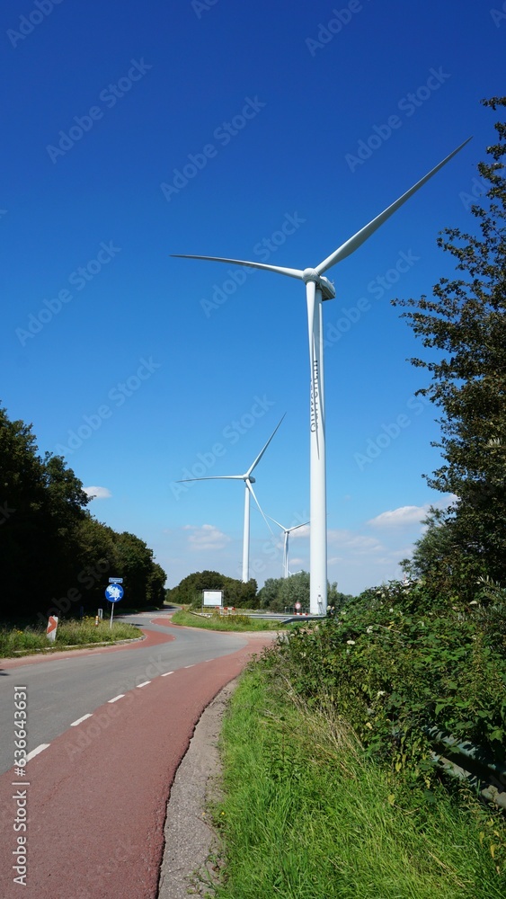 Windmill for green energy, wind turbine with blades that rotate on wind power and store in battery or accumulator to provide electricity to households.