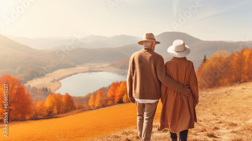 Senior Woman and Man Walking Hand in Hand in a Beautiful Autumn Landscape, Grateful Hearts, happy seniors celebrating Thanksgiving, wide banner with copy space area Generative AI
