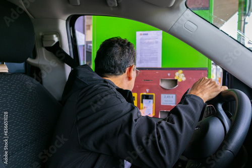 Adult male paying a toll on the highway photo