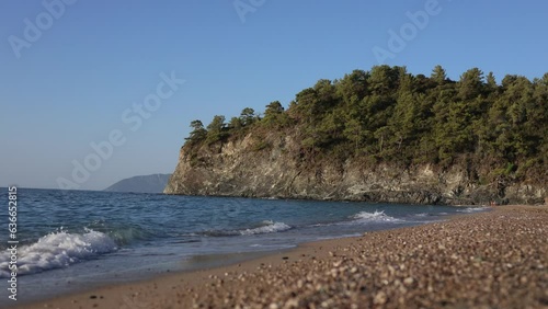 Beautiful landscape on the beach of mediterranean sea with mountains on background
