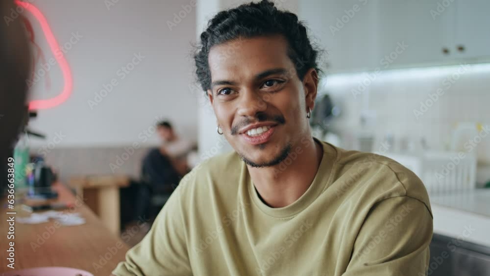Pierced man talking friendly meeting in cafeteria close up. Latin guy speaking Pierced man talking friendly meeting in cafeteria close up. Latin guy speaking