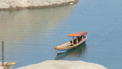 Boat sailing approaching island pier on Magat Lake during summer photo