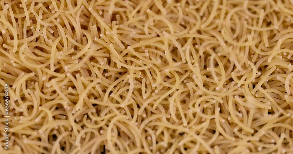 pour thin pasta made of high-quality wheat flour, uncooked pasta made of flour and water close-up pour thin pasta made of high-quality wheat flour, uncooked pasta made of flour and water close-up