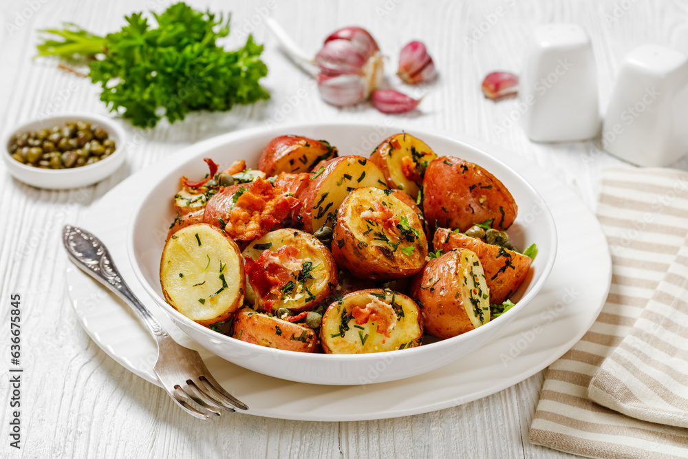 Herbs Garlic Potatoes in white bowl, top view Herbs Garlic Potatoes in white bowl, top view