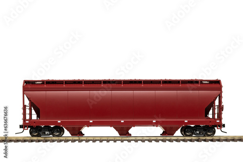 A maroon railroad grain hopper car on train track. photo