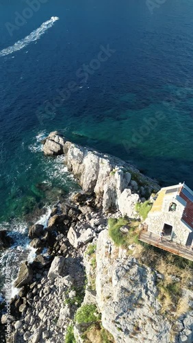 Church on the rock on Katic islet in Petrovac na Moru Aerial View. Beaches and coastline of the Adriatic Sea at summer time. Natural landscapes of Montenegro. Balkans. Europe. photo