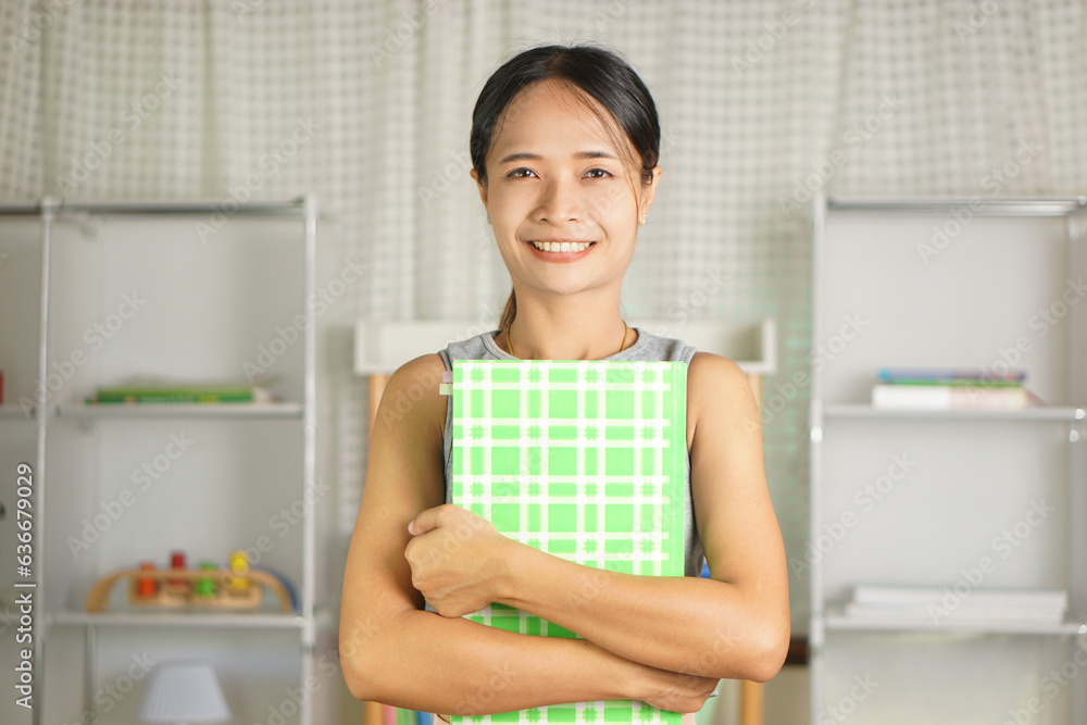 woman holding a green notebook Prepare for college woman holding a green notebook Prepare for college