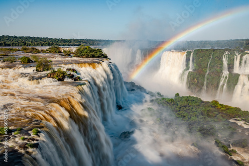 Perfect rainbow over Iguazu Waterfalls  one of the new seven natural wonders of the world in all its beauty viewed from the Brazilian side - traveling South America