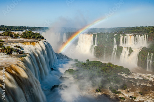 Perfect rainbow over Iguazu Waterfalls  one of the new seven natural wonders of the world in all its beauty viewed from the Brazilian side - traveling South America - long exposure