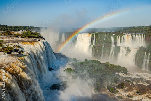 Perfect rainbow over Iguazu Waterfalls, one of the new seven natural wonders of the world in all its beauty viewed from the Brazilian side - traveling South America