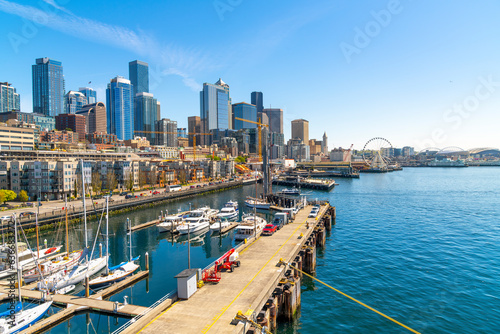 Panoramic view of the Seattle Waterfront along the Puget Sound with downtown district skyscrapers, the Pike Place Market district, and Great Wheel in view from the harbor in Seattle Washington, USA.  © Kirk Fisher
