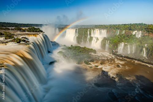 Perfect rainbow over Iguazu Waterfalls  one of the new seven natural wonders of the world in all its beauty viewed from the Brazilian side - traveling South America - long exposure
