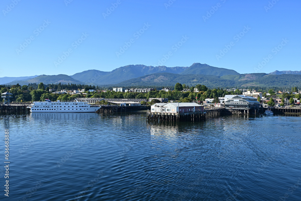 View of Port Angeles, Washington and Olympic Mountains from ferry in harbor on clear sunny summer morning.