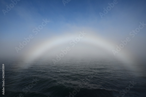 Bright fogbow in Juan de Fuca Strait off Port Angeles  Washington on sunny foggy summer morning.