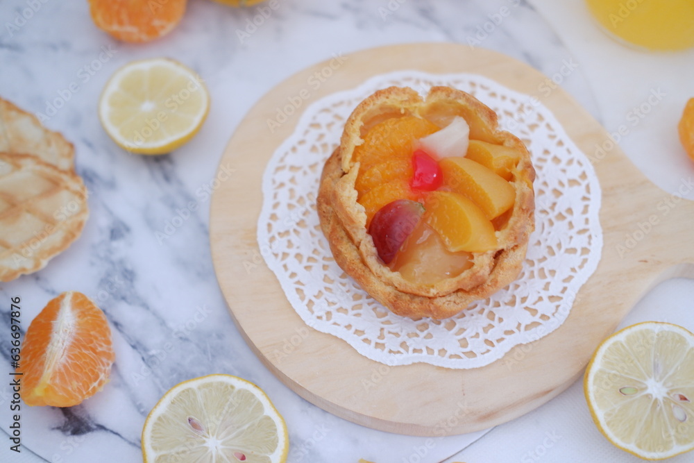 Homemade lemon tart with fresh fruit and orange juice on white background Homemade lemon tart with fresh fruit and orange juice on white background