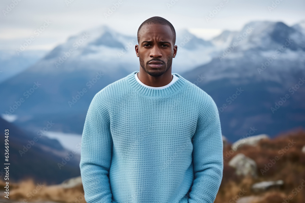 Sadness African Man In Blue Cardigan On Mountain Scenery Background Sadness African Man In Blue Cardigan On Mountain Scenery Background
