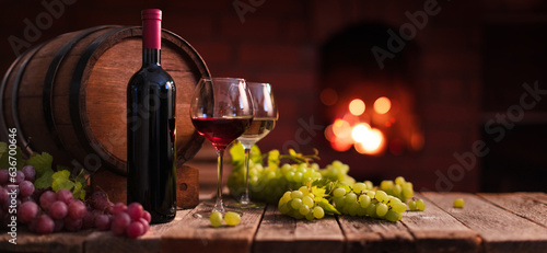 Fototapeta Naklejka Na Ścianę i Meble -  Red and white wine. A glass of red and white wine with grapes on the background of a homemade fireplace