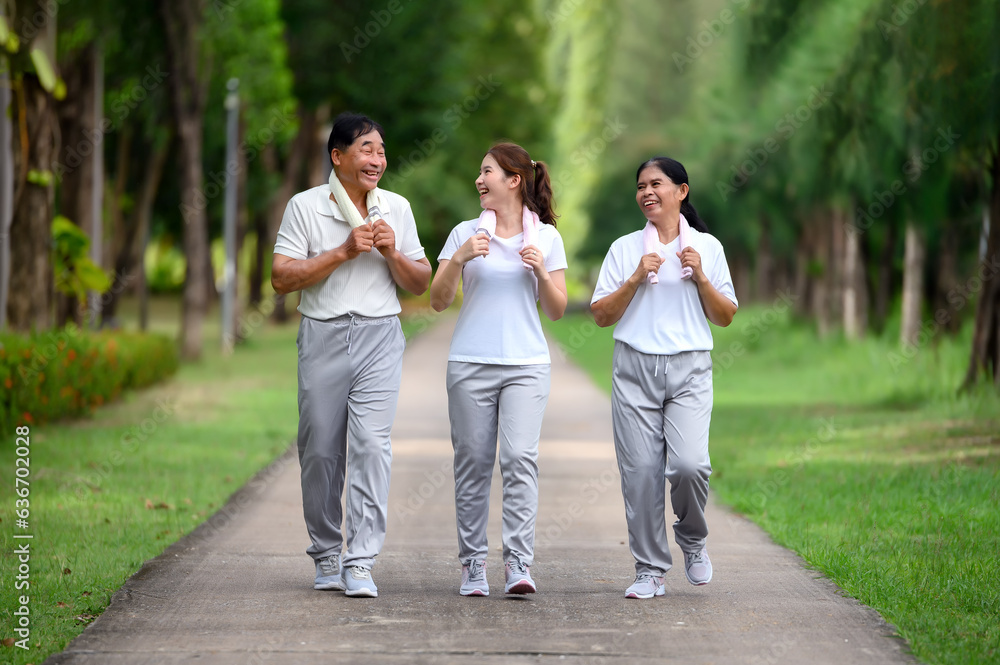 Asian Seniors and Daughter Jogging and Relaxing in the Park, Family Bonding in Nature, Seniors and Family Enjoying Exercise and Relaxation in the Green Park, Health Care and Family Bonding Concept Asian Seniors and Daughter Jogging and Relaxing in the Park, Family Bonding in Nature, Seniors and Family Enjoying Exercise and Relaxation in the Green Park, Health Care and Family Bonding Concept