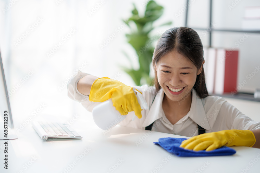 Asian young cleaning service woman worker clean table at home. Beautiful young girl housekeeper cleaner feel happy and wiping messy dirty counter for housekeeping housework or chores. Asian young cleaning service woman worker clean table at home. Beautiful young girl housekeeper cleaner feel happy and wiping messy dirty counter for housekeeping housework or chores.