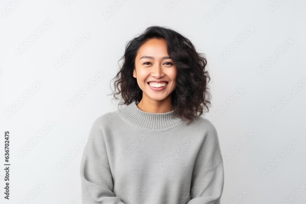Medium shot portrait of a Indonesian woman in her 30s in a white background wearing a cozy sweater Medium shot portrait of a Indonesian woman in her 30s in a white background wearing a cozy sweater